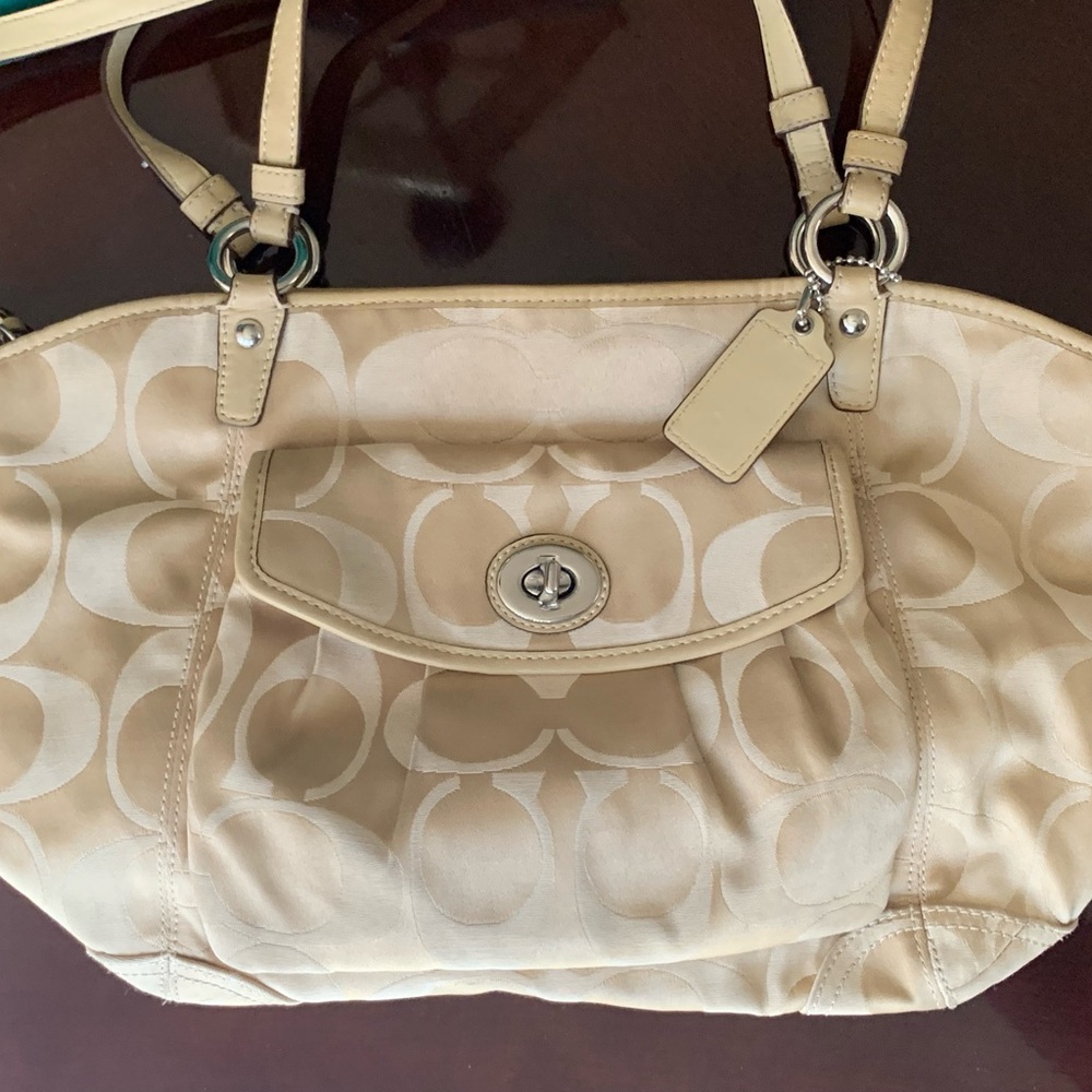 Coach top handle tote with a long strap.